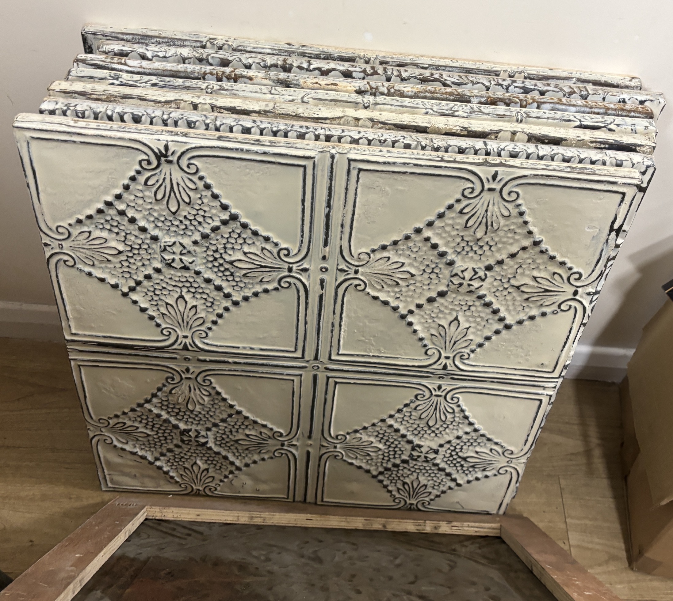 A group of nine decorative pressed tin panels made from salvaged antique tin ceilings, 59cm square